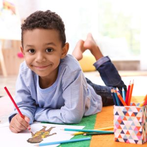 Child drawing with colored pencils